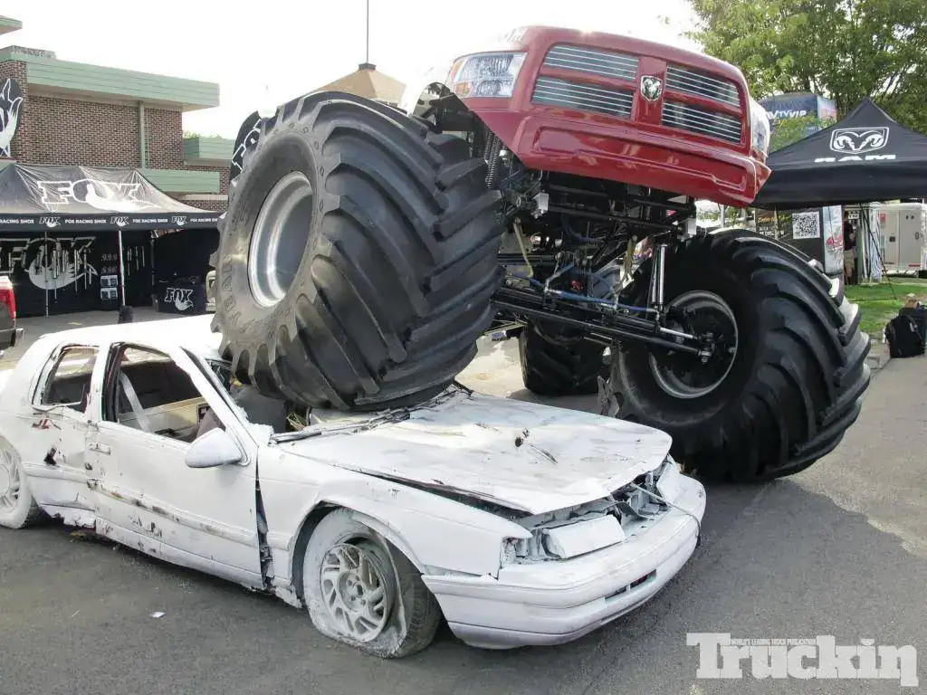 1303tr_01+31st_annual_4wheel_jamboree_nationals+ram_monster_truck_crushing_car.webp