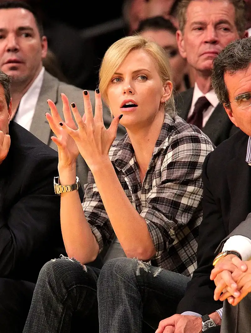 harlize-Theron-Rolex-DEEP-SEA-Lakers-Game-Clapping.webp