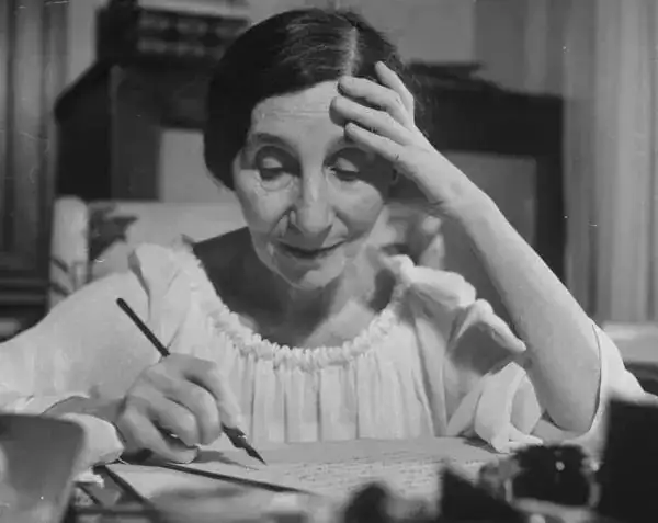 Harpsichordist Wanda Landowska, at home writing. 1949.webp