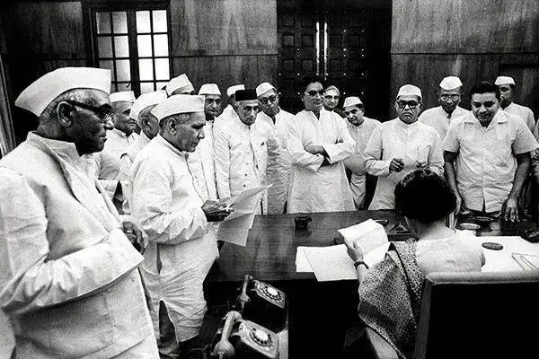 Indira Gandhi with Congressmen at her office in Parliament House in 1966.webp